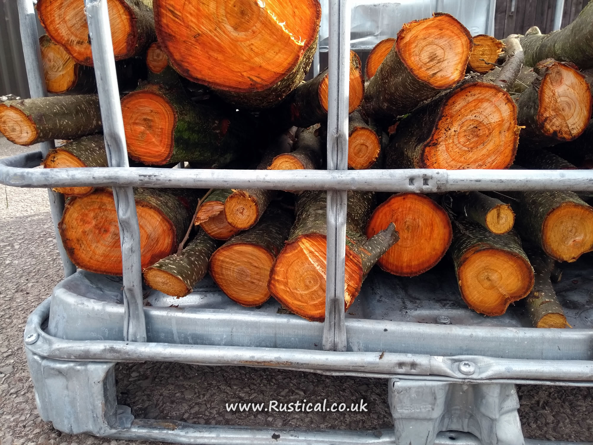 Coppiced Alder stacked in an IBC crate to season
