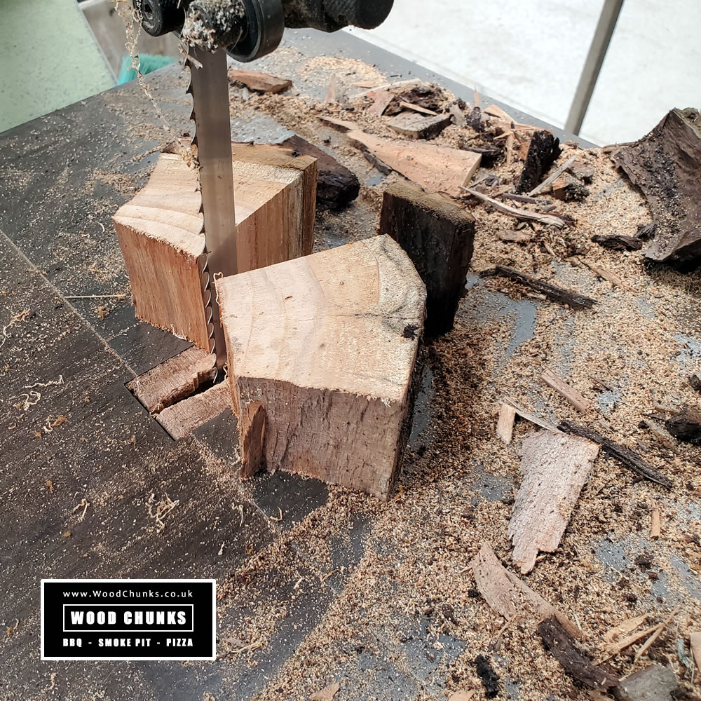 Sawing cherry wood chunks for barbeque smokers